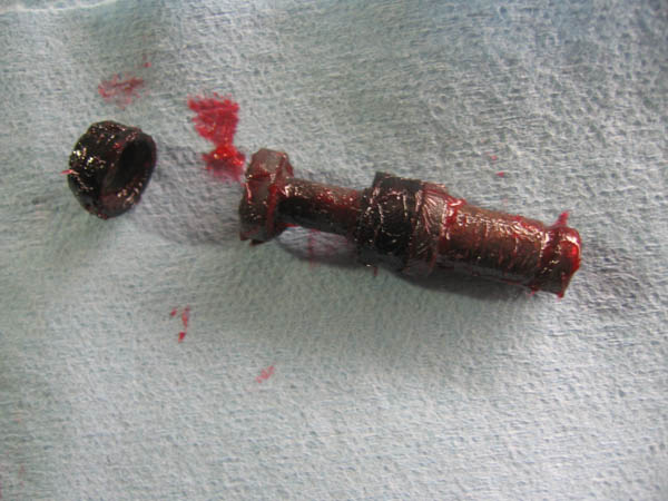 motorcycle tip rebuild brake plunger smeared with red rubber grease