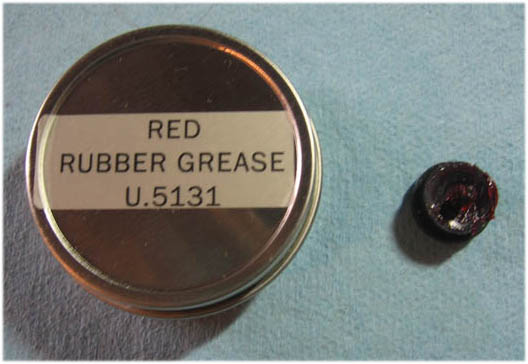 image of how to lubricate double flare brake tool die with red rubber grease