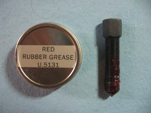 image of how to lubricate double flare brake line tool screw with red rubber grease